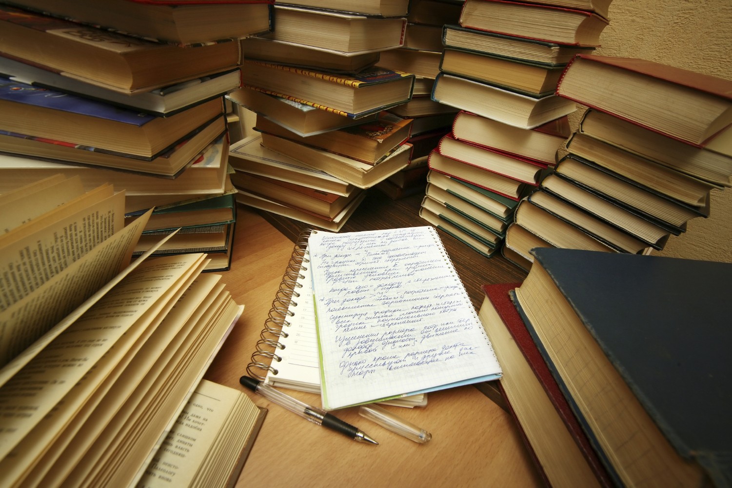 stack of books surrounding notepad