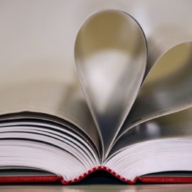 book with open pages shaped into a heart