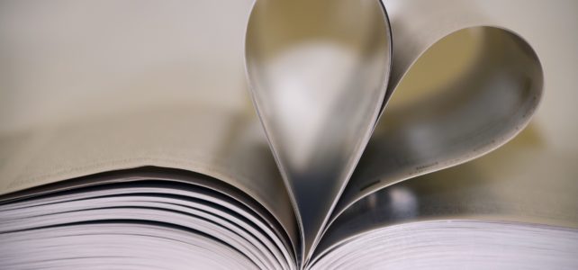 book with open pages shaped into a heart